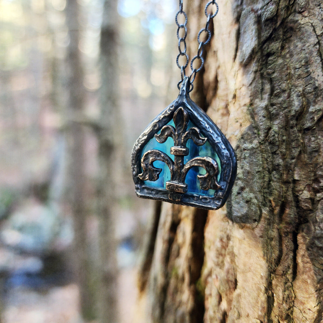 fleur de lis - iridescent aqua arch window amulet - antiqued sterling & bronze