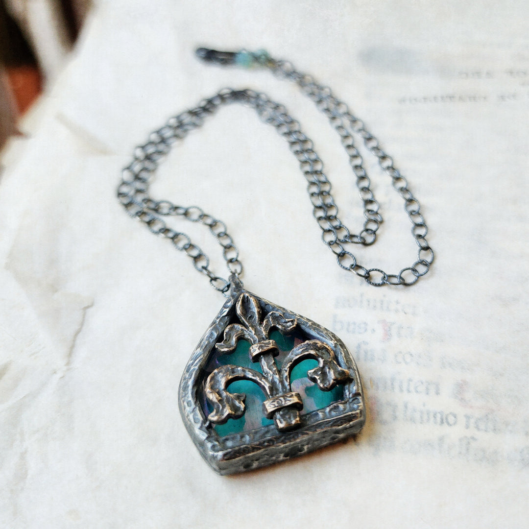 fleur de lis - iridescent aqua arch window amulet - antiqued sterling & bronze