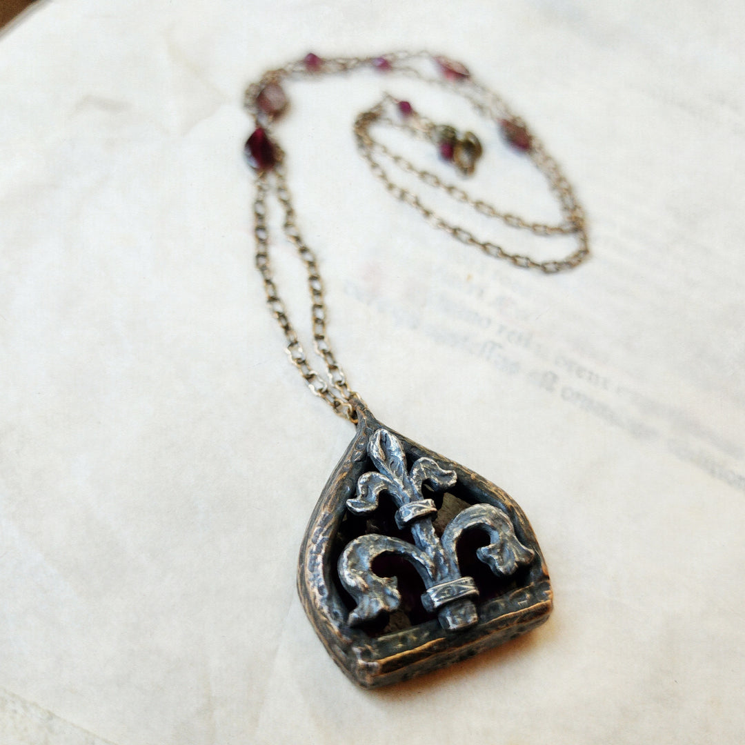fleur de lis - garnet arch window amulet - antiqued sterling & bronze