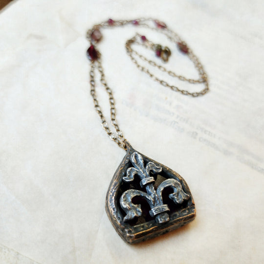 fleur de lis - garnet arch window amulet - antiqued sterling & bronze