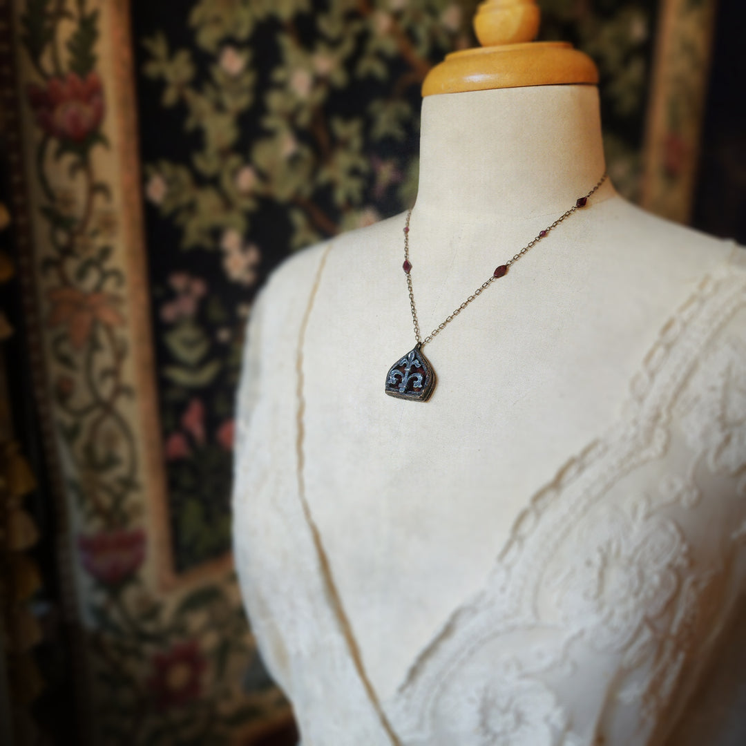 fleur de lis - garnet arch window amulet - antiqued sterling & bronze
