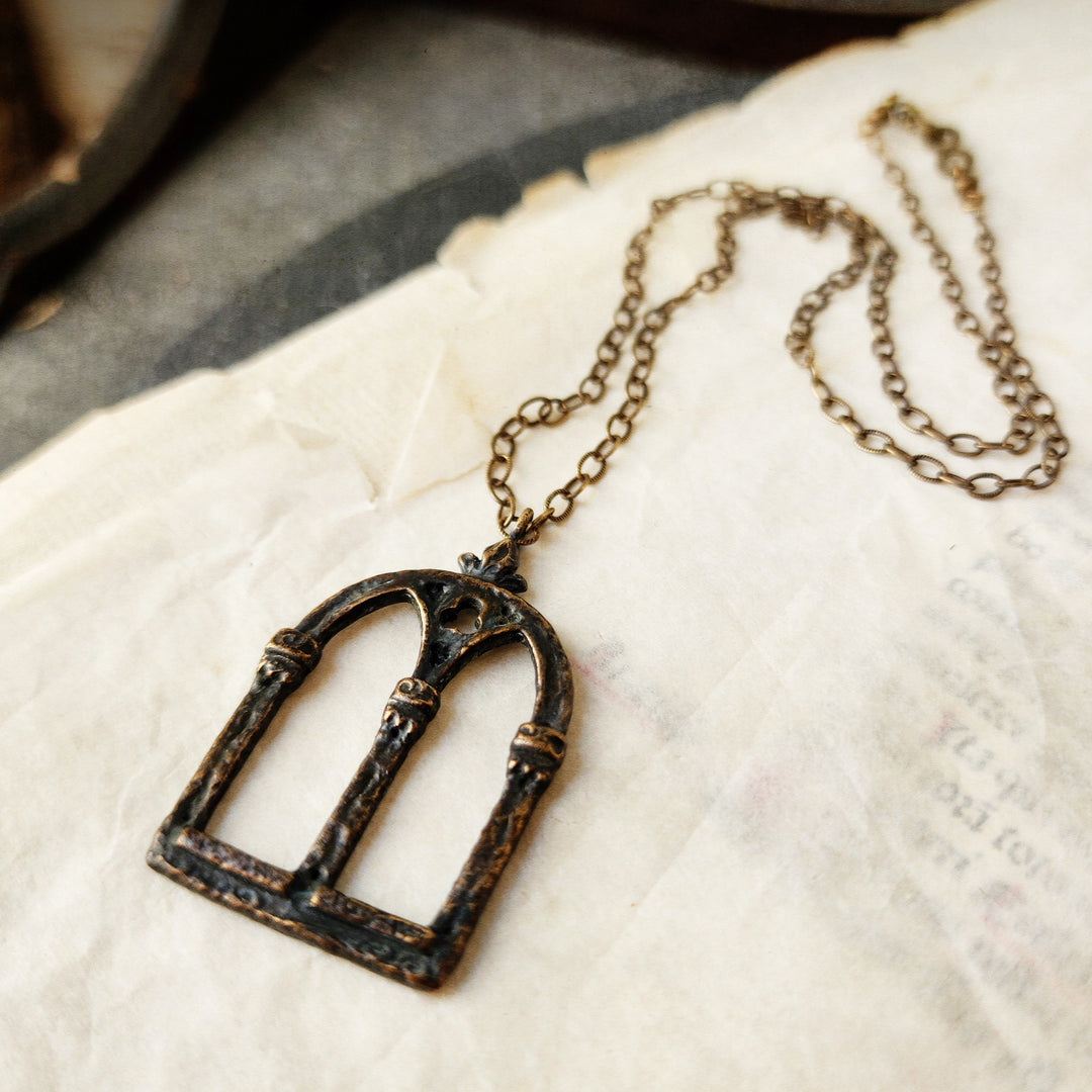 crowned queen isabella window amulet - antiqued bronze