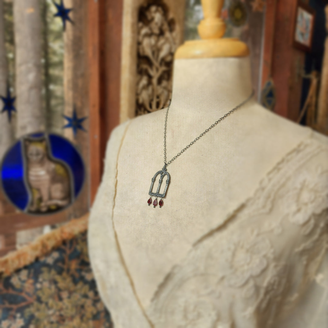 crowned queen isabella window amulet - antiqued sterling garnet