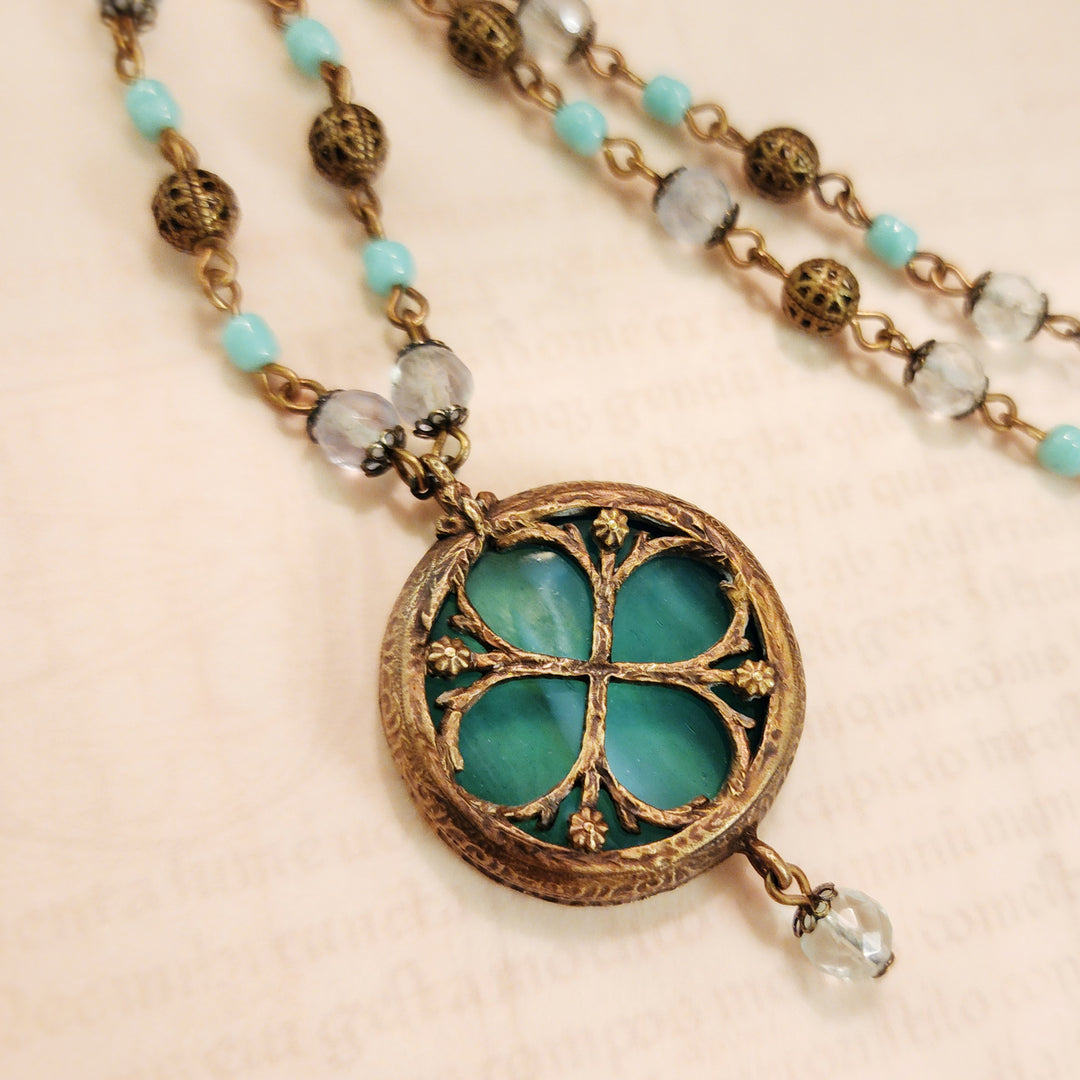theia - floriated clover miracle window amulet