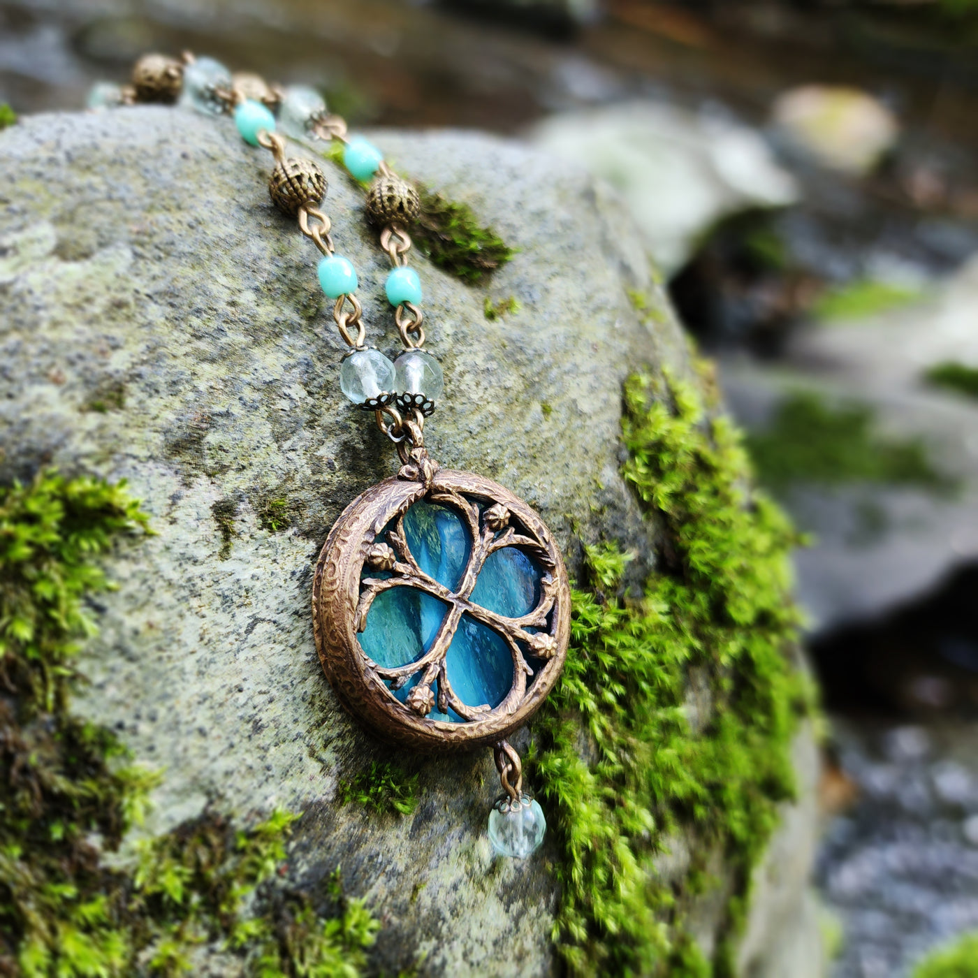 theia - floriated clover miracle window amulet