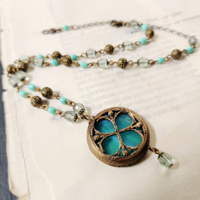 theia - floriated clover miracle window amulet