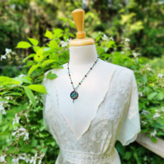 theia - floriated clover miracle window amulet