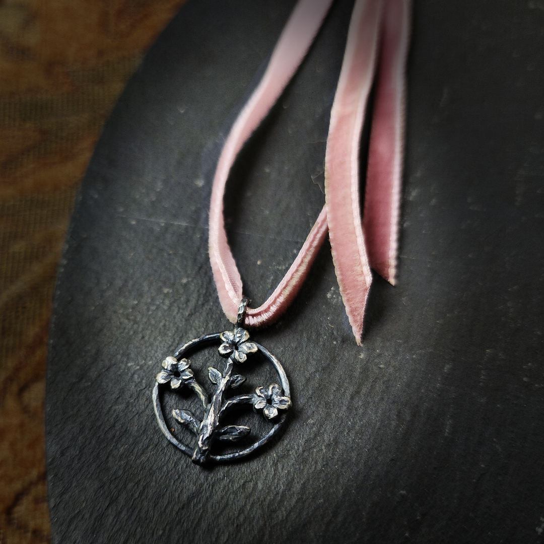 trois fleurs sacrées amulet - antiqued sterling on velvet ribbon