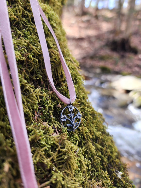 trois fleurs sacrées amulet - antiqued sterling on velvet ribbon