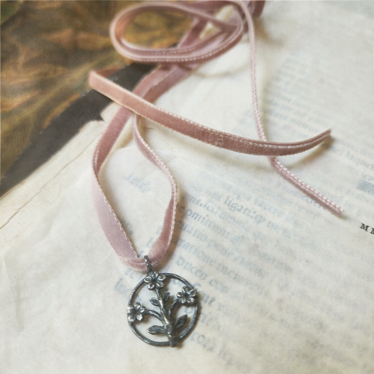 trois fleurs sacrées amulet - antiqued sterling on velvet ribbon