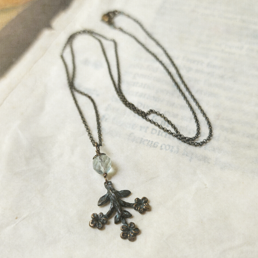 trois fleurs sacrées amulet - antiqued bronze with fluorite